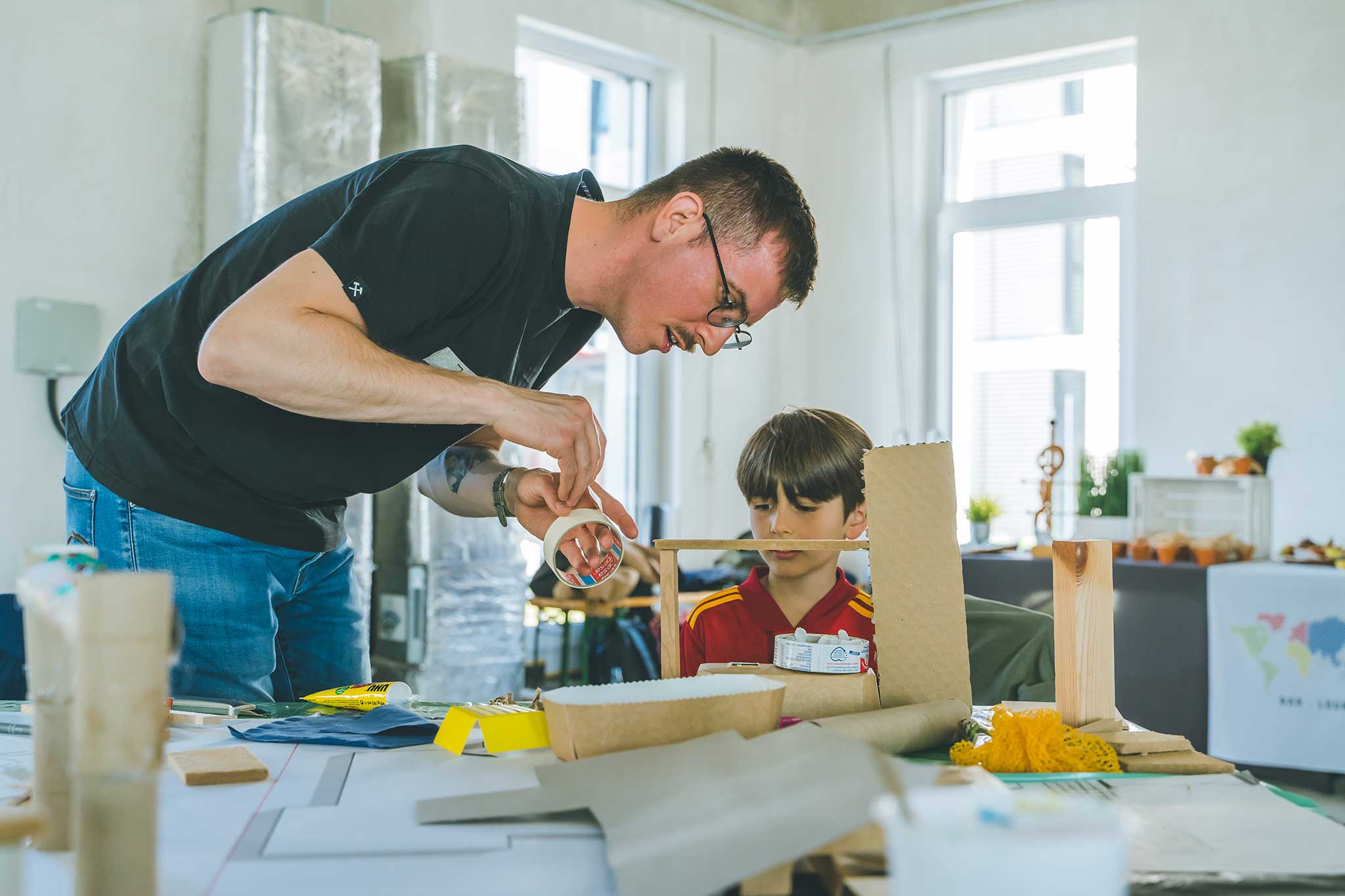 Workshop Kletterspielplatz. Ein Junge baut ein Modell für ein Klettergerüst.